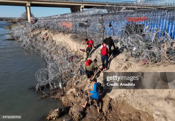 An aerial view shows an immigrant group trying to cross the Texan border despite heightened security measures in Eagle Pass, Texas on February 03,...
