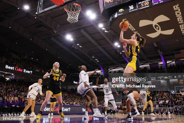 Caitlin Clark of the Iowa Hawkeyes scores her 3,403 career point, passing Kelsey Mitchell for second in Division I NCAA women's basketball history,...