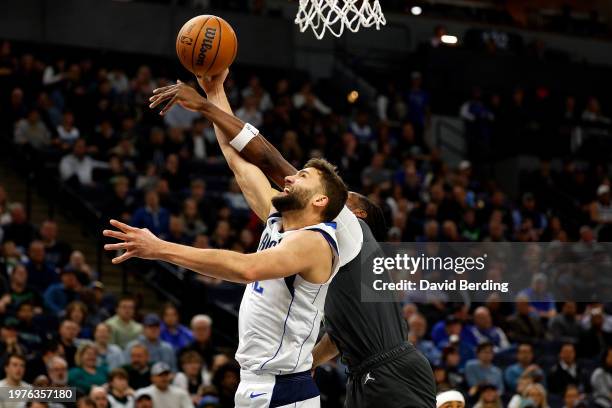 Naz Reid of the Minnesota Timberwolves blocks a shot by Maxi Kleber of the Dallas Mavericks in the first quarter at Target Center on January 31, 2024...