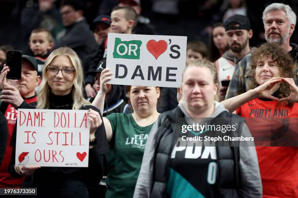 Fans watch as Damian Lillard of the Milwaukee Bucks warms up before his return against the Portland Trail Blazers at Moda Center on January 31, 2024...