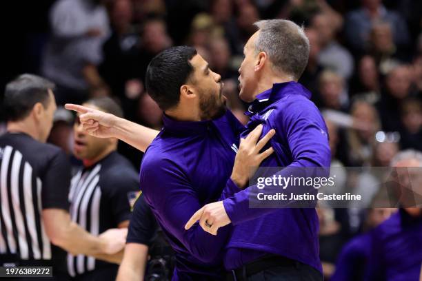 Head coach Chris Collins of the Northwestern Wildcats is held back after receiving a technical foul in the second half against the Purdue...