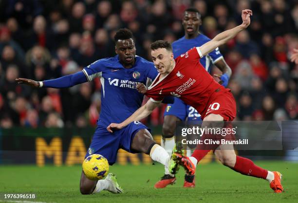 Diogo Jota of Liverpool scores his team's first goal whilst under pressure from Benoit Badiashile of Chelsea during the Premier League match between...