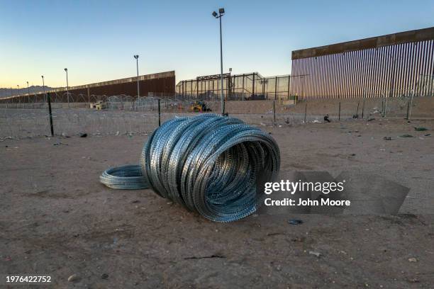 Coils of razor wire sit ready to be deployed by Texas National Guard troops in El Paso, Texas on January 31, 2024 across the border from Ciudad...