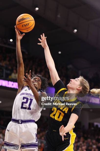 Melannie Daley of the Northwestern Wildcats shoots over Kate Martin of the Iowa Hawkeyes during the second half at Welsh-Ryan Arena on January 31,...