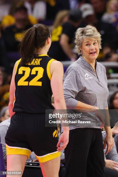 Caitlin Clark of the Iowa Hawkeyes laughs with head coach Lisa Bluder against the Northwestern Wildcats during the second half at Welsh-Ryan Arena on...