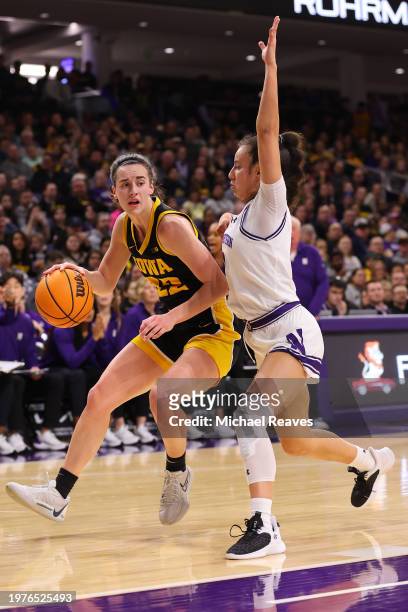 Caitlin Clark of the Iowa Hawkeyes drives to the basket against the Northwestern Wildcats during the first half at Welsh-Ryan Arena on January 31,...
