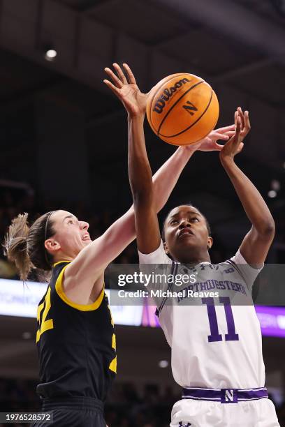 Caitlin Clark of the Iowa Hawkeyes blocks a shot by Hailey Weaver of the Northwestern Wildcats during the second half at Welsh-Ryan Arena on January...