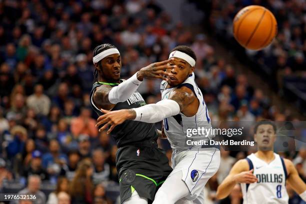 Jaden McDaniels of the Minnesota Timberwolves passes the ball while Richaun Holmes of the Dallas Mavericks defends in the third quarter at Target...