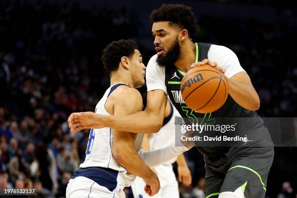 Karl-Anthony Towns of the Minnesota Timberwolves drives to the basket while Josh Green of the Dallas Mavericks defends in the third quarter at Target...