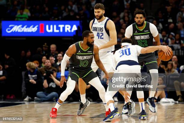 Seth Curry of the Dallas Mavericks dribbles the ball while Mike Conley of the Minnesota Timberwolves defends in the third quarter at Target Center on...