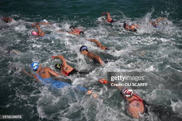 Swimmers compete in the final of the men's 10km open water swimming event during the 2024 World Aquatics Championships at Doha Port in Doha on...