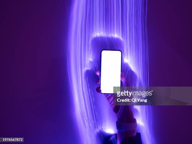 close-up of smartphone and long exposure of optical fiber - qi yang stock pictures, royalty-free photos & images