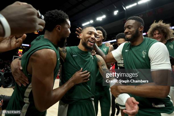 Damian Lillard of the Milwaukee Bucks has his teammates cheer him on as the crowd acknowledges himduring his return against the Portland Trail...