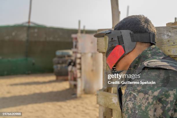 men with paintball equipment ready to play - run hide fight stock pictures, royalty-free photos & images