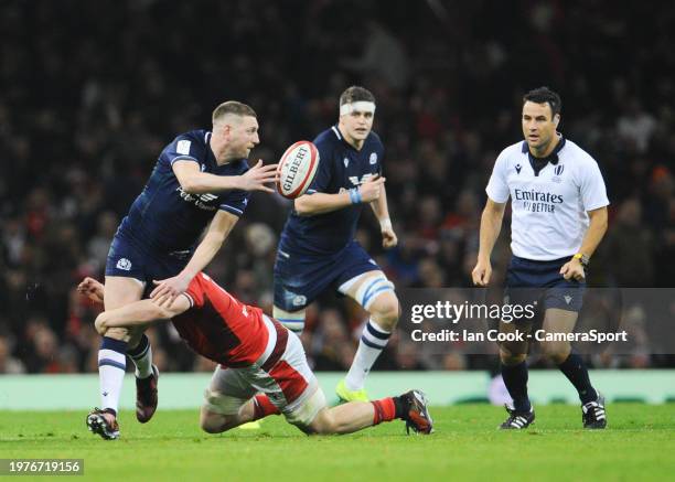 Scotland's Finn Russell manages to offload while being tackled by Wales Tommy Reffell during the Guinness Six Nations 2024 match between Wales and...