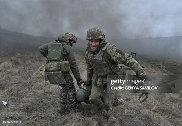 Ukrainian servicemen of the Skala battalion perform a medical evacuation during a field military exercise in the Donetsk region on February 3 amid...