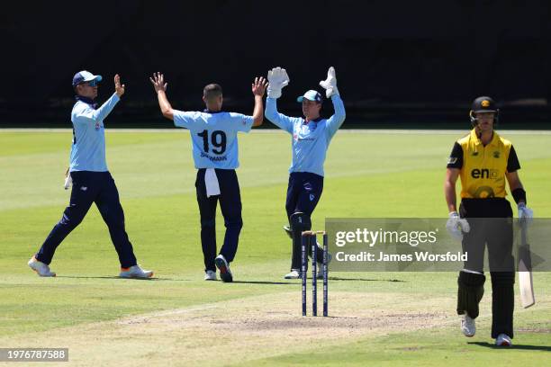 Chris Green, William Salzmann and Matthew Gilkes of New South Wales celebrate the last wicket of the innings during the Marsh One Day Cup match...