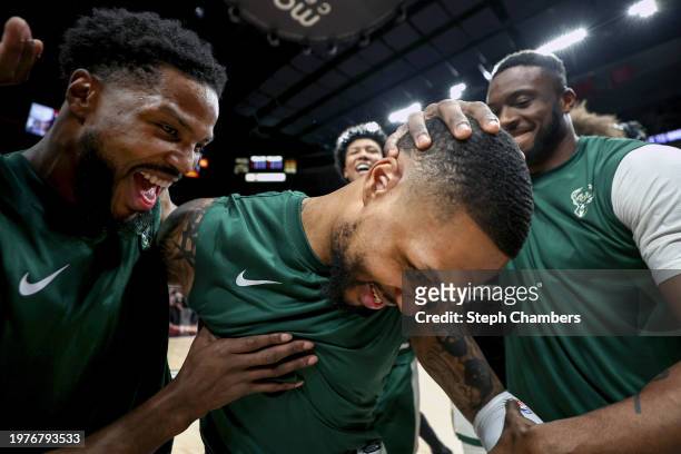 Damian Lillard of the Milwaukee Bucks has his teammates cheer him on as the crowd acknowledges him during his return against the Portland Trail...