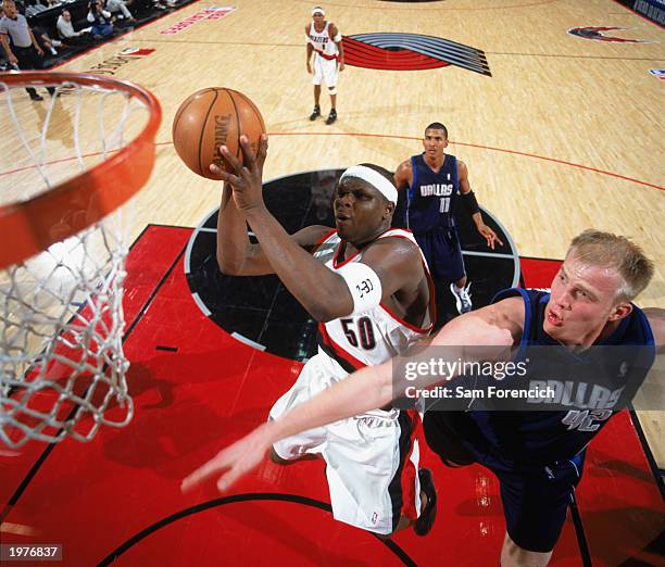 Zach Randolph of the Portland Trail Blazers contests the defense of Evan Eschmeyer of the Dallas Mavericks in Game Four of the Western Conference...