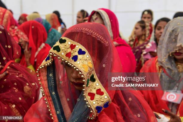 Muslim brides attend a mass marriage ceremony organised by Gujarat Sarvajanik Welfare trust in Ahmedabad on February 4 where around 130 couples tied...