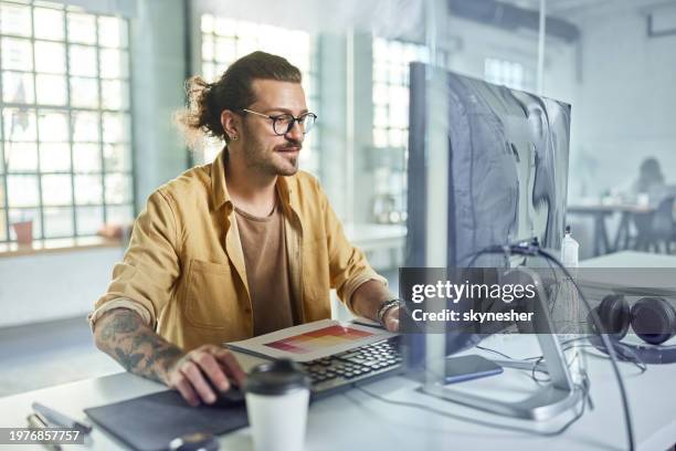 young male programmer working on desktop pc in the office. - graphic designer stock pictures, royalty-free photos & images