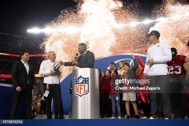 Fox Sports broadcaster Michael Strahan interviews CEO Jed York and alumnus Joe Montana of the San Francisco 49ers after the NFC Championship game...