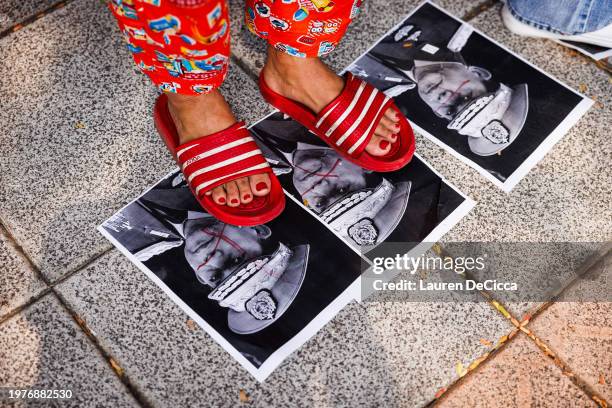 Myanmar people step on photos of military junta leader, General Min Aung Hlaing, during a gathering at the United Nations on February 01, 2024 in...