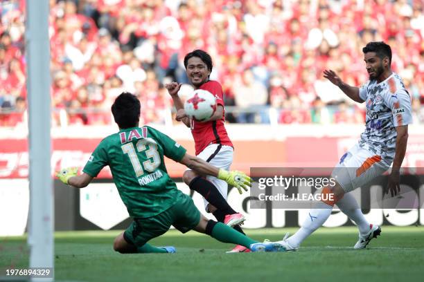 Shinzo Koroki of Urawa Red Diamonds scores the team's third and hat trick goal past Yuij Rokutan of Shimizu S-Pulse during the J.League J1 match...