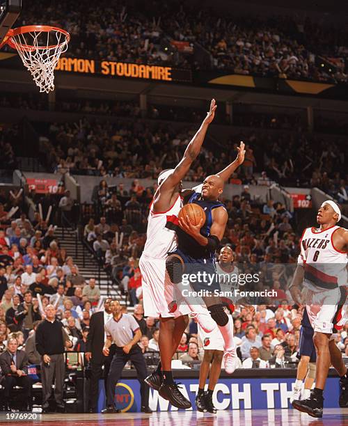 Nick Van Exel of the Dallas Mavericks heads to the hoop against Rasheed Wallace of the Portland Trail Blazers in Game Four of the Western Conference...