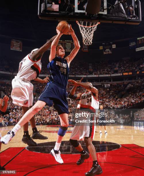 Shawn Bradley of the Dallas Mavericks is under pressure from Zach Randolph and Dale Davis of the Portland Trail Blazers in Game Four of the Western...