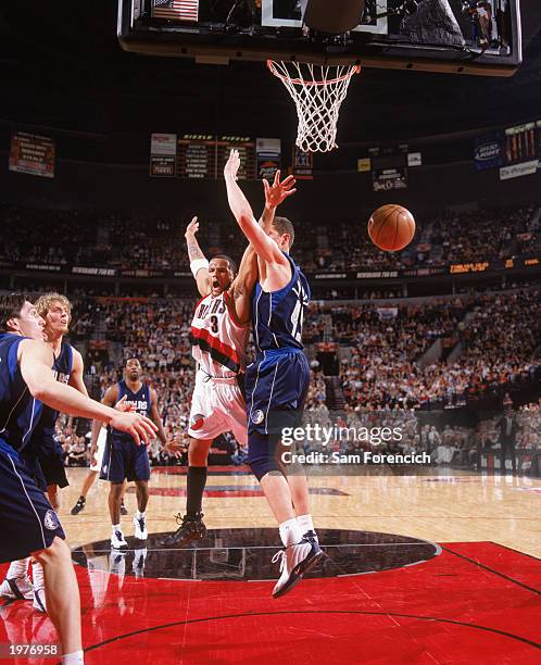 Damon Stoudamire of the Portland Trail Blazers makes the pass against Raef LaFrentz of the Dallas Mavericks in Game Four of the Western Conference...