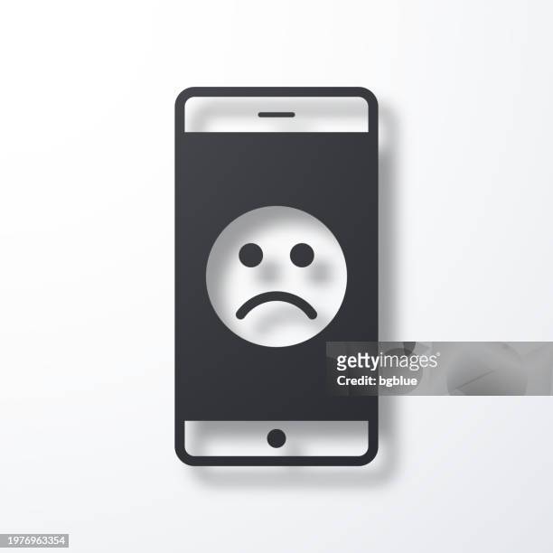 smartphone with sad emoji. icon with shadow on white background - disappointing phone stock illustrations