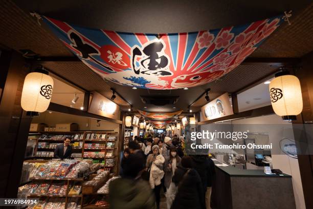 People shop at a store in the Toyosu Senkyaku Banrai shopping complex on February 01, 2024 in Tokyo, Japan. The facility that was built as a part of...