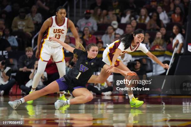 Washington Huskies guard Hannah Stines and Southern California Trojans guard Kayla Padilla reach for the ball during an NCAA college women's...