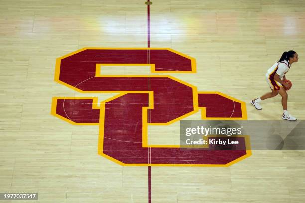 Southern California Trojans guard McKenzie Forbes dribbles on the SC logo at center court against the Washington Huskies during an NCAA college...