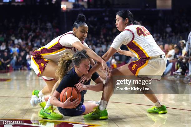 Washington Huskies guard Elle Ladine battles for the ball with Southern California Trojans guard JuJu Watkins andguard Kayla Padilla during an NCAA...