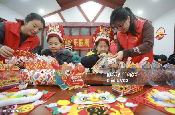 Children learn to make paper dragons to celebrate the upcoming Year of the Dragon on February 1, 2024 in Yangzhou, Jiangsu Province of China. The...
