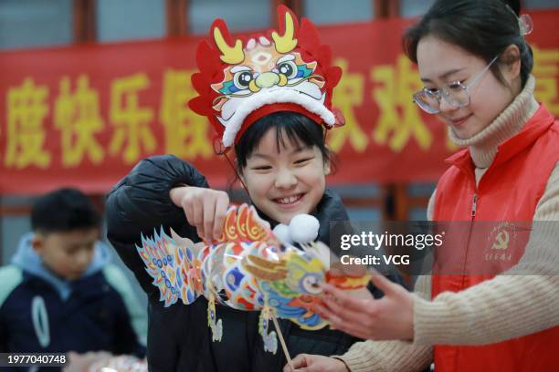 Child learns to make paper dragons to celebrate the upcoming Year of the Dragon on February 1, 2024 in Yangzhou, Jiangsu Province of China. The...