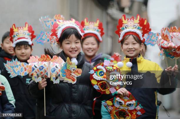 Children show their handmade paper dragons to celebrate the upcoming Year of the Dragon on February 1, 2024 in Yangzhou, Jiangsu Province of China....