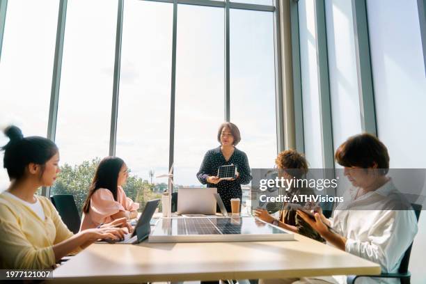 eco-conscious business meeting discussing solar energy investments - embracing esg principles - sustainable business stock pictures, royalty-free photos & images