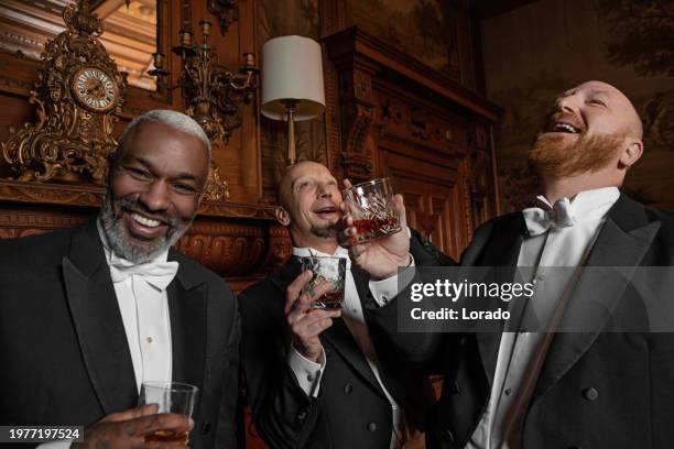 three handsome 1920s style gentlemen in a drawing room - high society stock-fotos und bilder