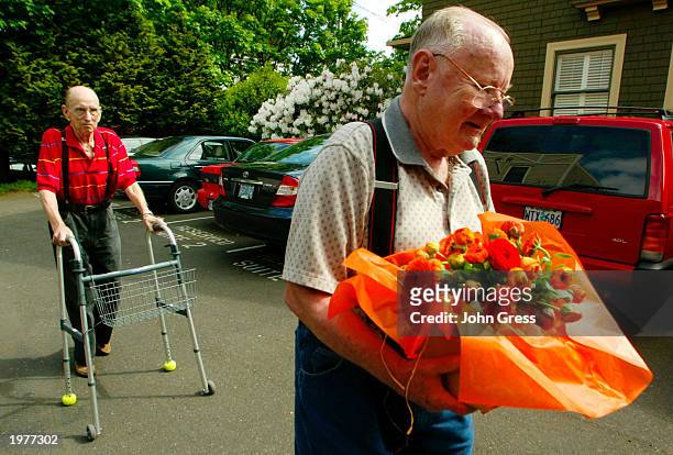 Dr. Al Willeford makes his way to a car as his friend, Dr. David Holmes , carries flowers that were given to Willeford during a news conference held...