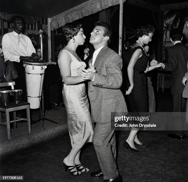 Man spots something interesting on the ceiling as he and his partner dance on the dancefloor at Club Tahiti, a nightclub in the crypt of St Anne's...