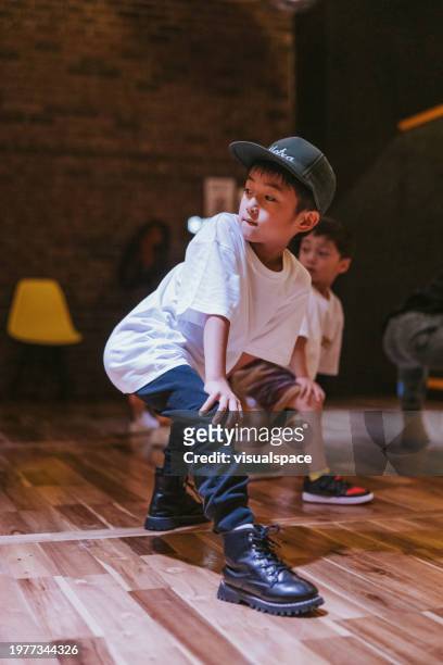 stylish japanese boy dancing at a hiphop class - just dance 3 stock pictures, royalty-free photos & images