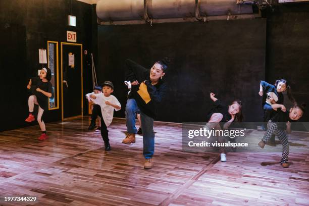 japanese kids dancing with their instructor in a dance studio - hip hop culture stock pictures, royalty-free photos & images