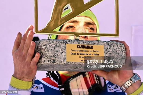 First placed Switzerland's Daniel Yule celebrates on the podium with his award after winning the Men's Slalom event during the FIS Alpine ski World...