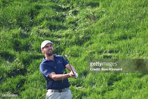 Joost Luiten of Netherlands pitches onto the 14th green during Day One of the Bahrain Championship presented by Bapco Energies at Royal Golf Club on...