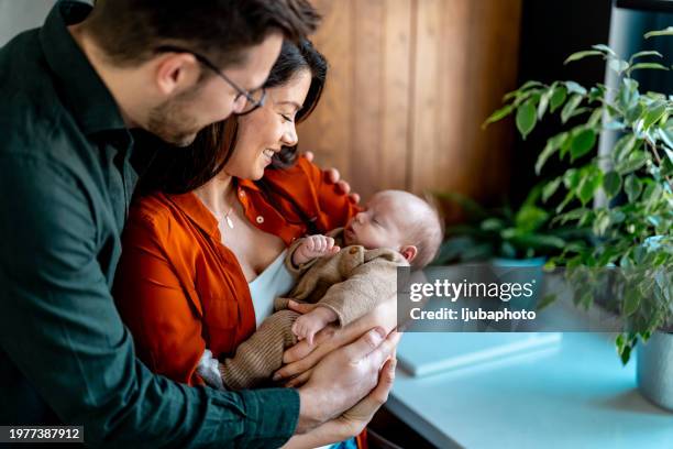 spending time with our new family member - two parents stock pictures, royalty-free photos & images