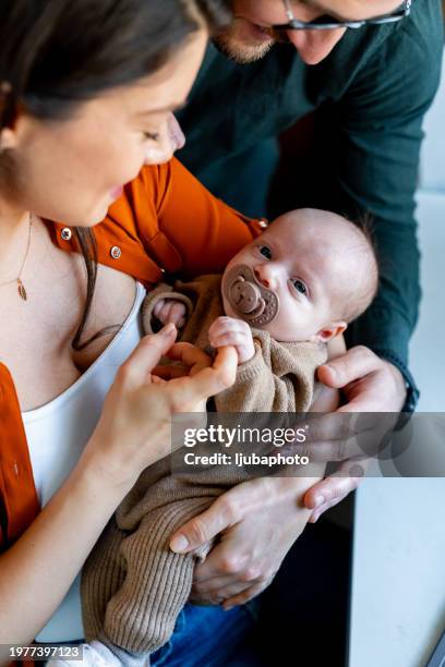 newborn baby holding fingers mother's hand. - baby boys stock pictures, royalty-free photos & images