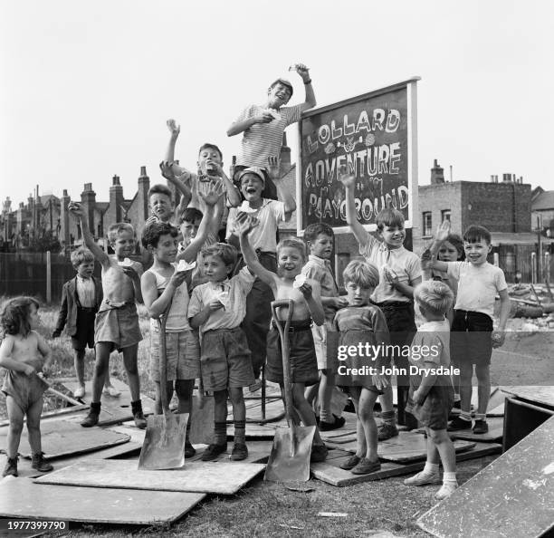 Children eating ice cream and waving at the Lollard Adventure Playground in Lambeth, London, August 1955.